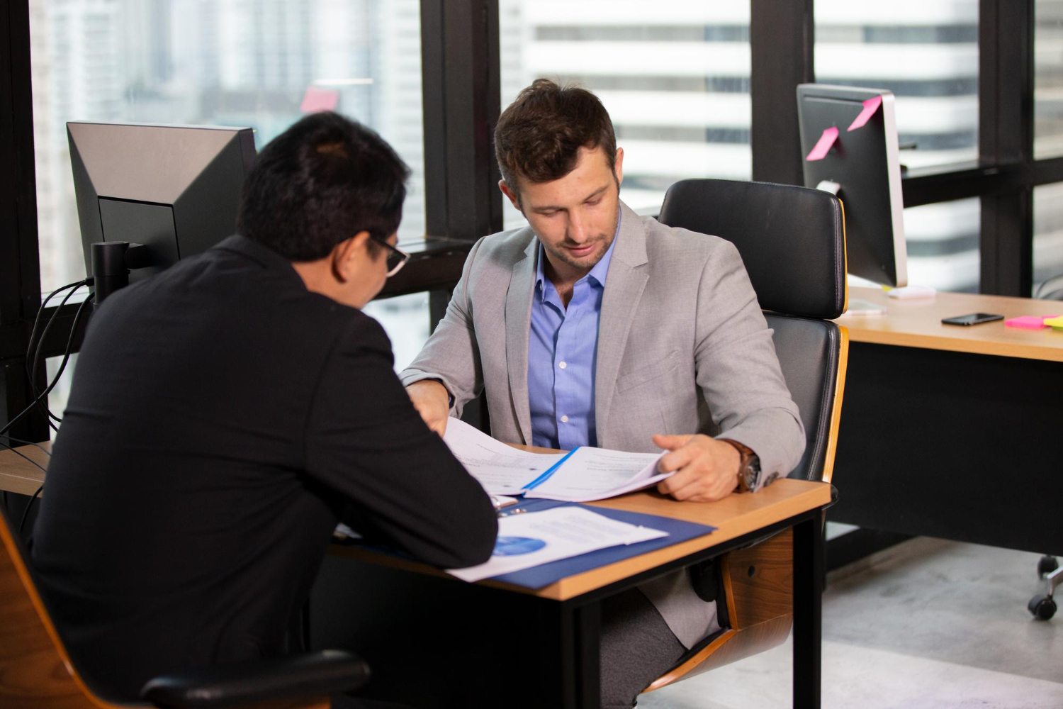 Business owner with advisor filing paperwork.