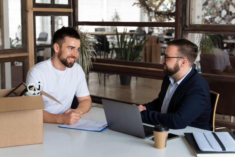 A professional advisor helping a client fill insurance claim forms.